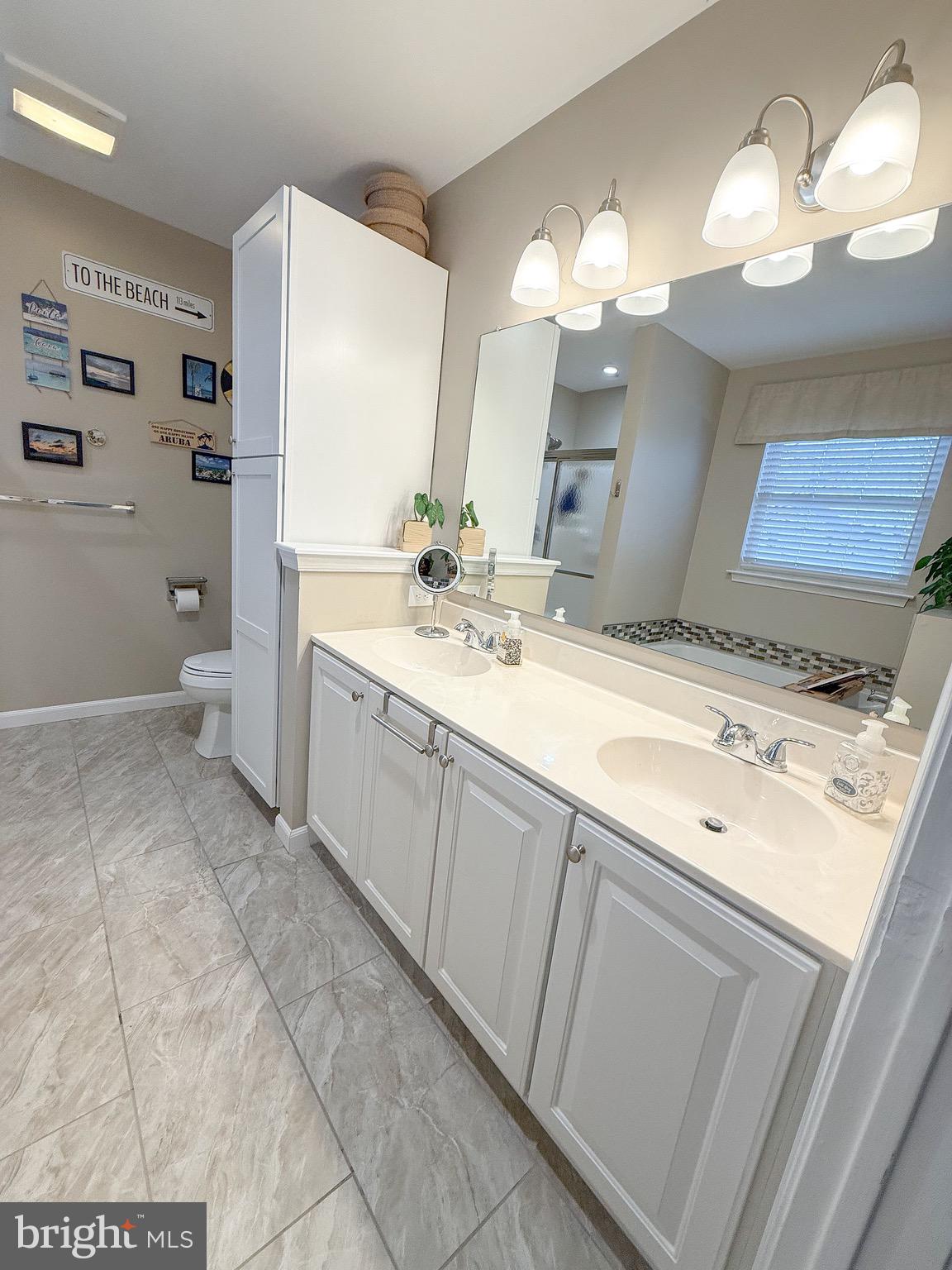 121 Chestnut Drive Elkton, MD 21921 - Photo 14 of 20 a spacious bathroom with a granite countertop sink a toilet and a mirror