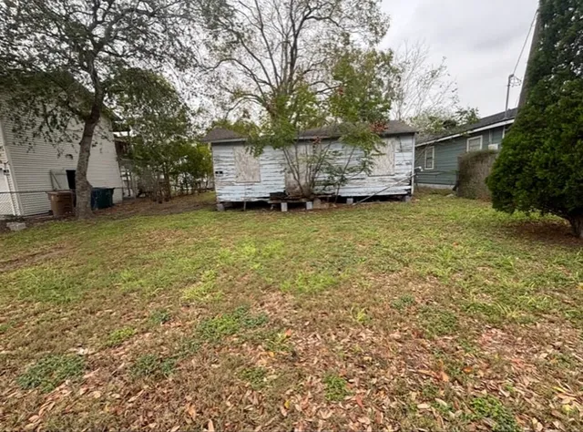 a backyard of a house with table and chairs