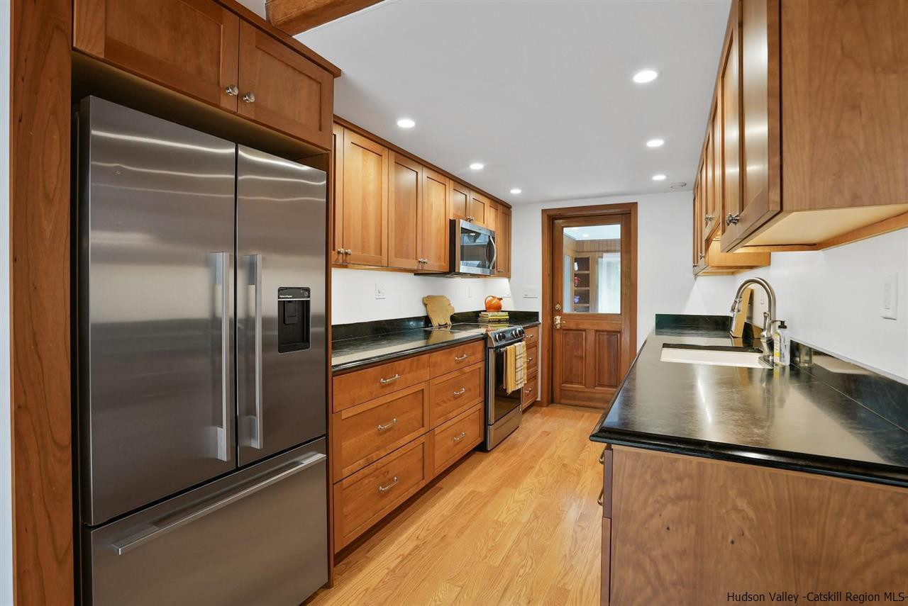 48 Rock Ridge Road New Paltz, NY 12561 - Photo 14 of 35 a kitchen with stainless steel appliances granite countertop a refrigerator a sink and a stove