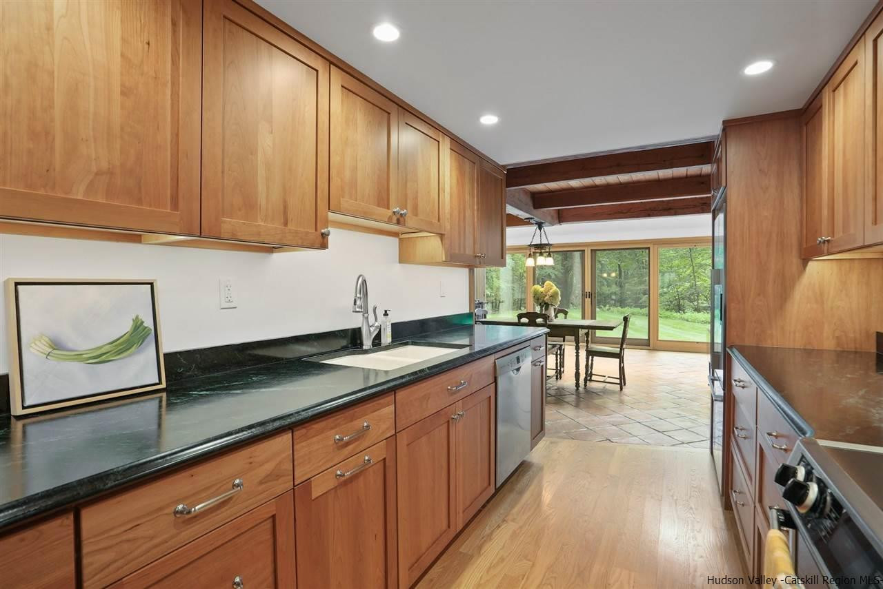 48 Rock Ridge Road New Paltz, NY 12561 - Photo 15 of 35 a kitchen with stainless steel appliances granite countertop sink stove top oven and cabinets