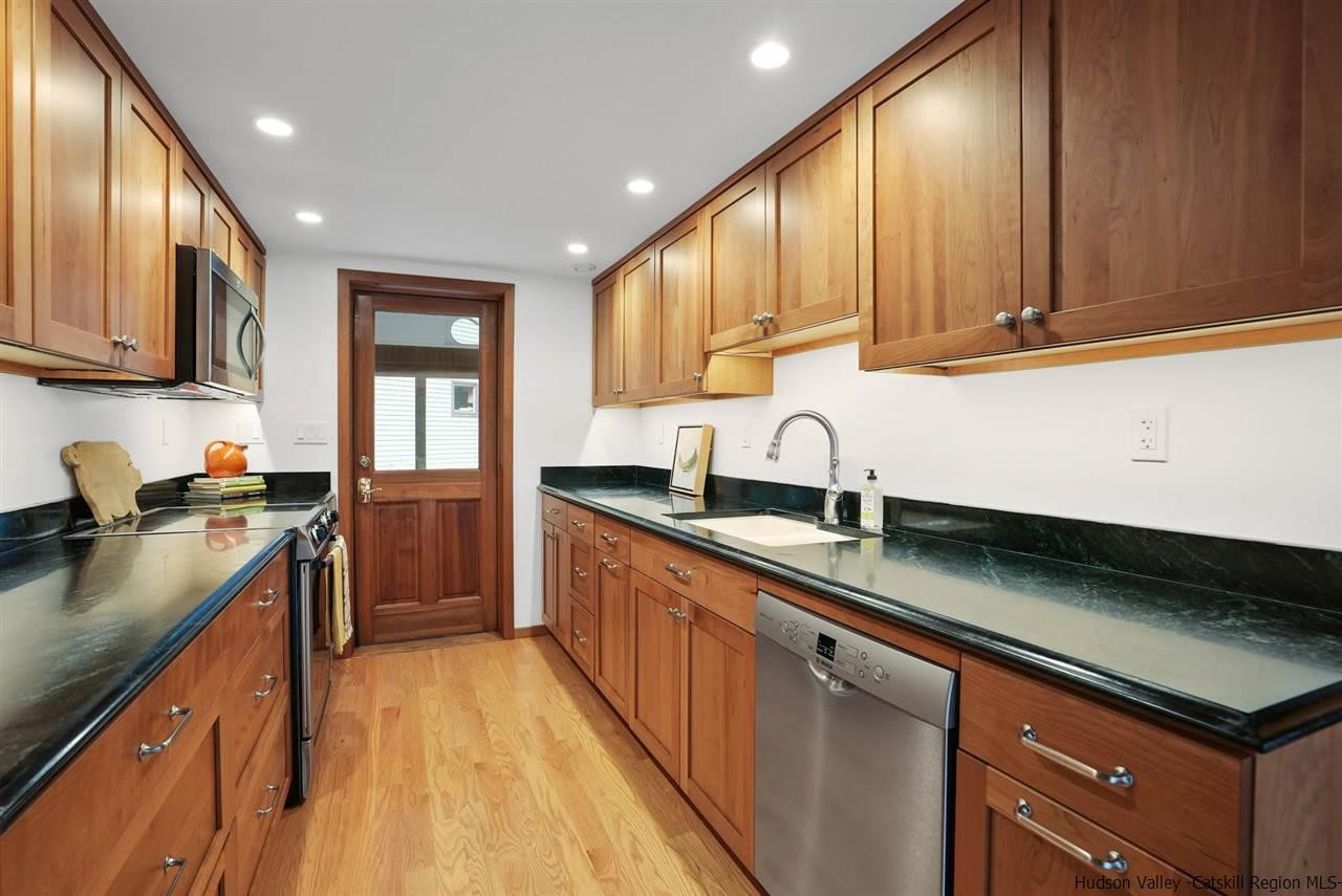 48 Rock Ridge Road New Paltz, NY 12561 - Photo 16 of 35 a kitchen with stainless steel appliances granite countertop a sink a stove and a refrigerator