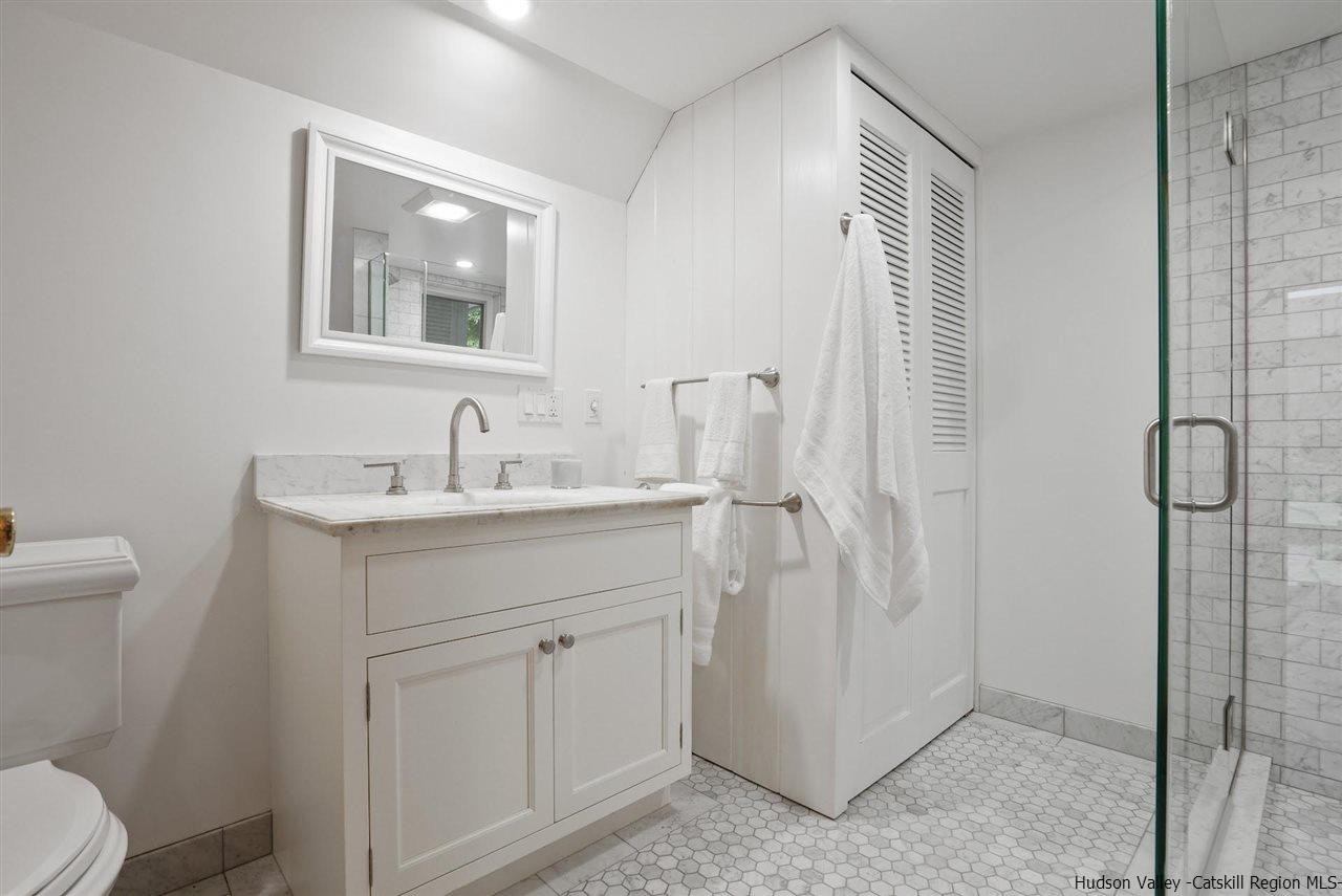 48 Rock Ridge Road New Paltz, NY 12561 - Photo 17 of 35 a bathroom with a sink a toilet a shower and a mirror