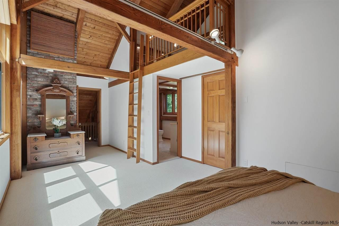 48 Rock Ridge Road New Paltz, NY 12561 - Photo 20 of 35 a bedroom with a large bed and a large window