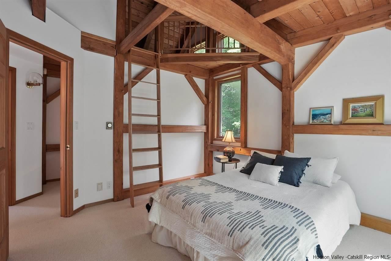 48 Rock Ridge Road New Paltz, NY 12561 - Photo 26 of 35 a bedroom with a bed a dresser and a large window
