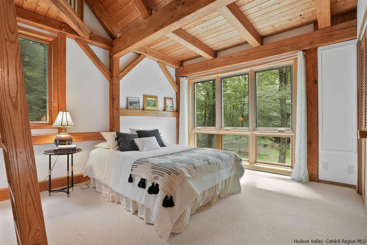48 Rock Ridge Road New Paltz, NY 12561 - Photo 27 of 35 a bed sitting in a bedroom next to a window