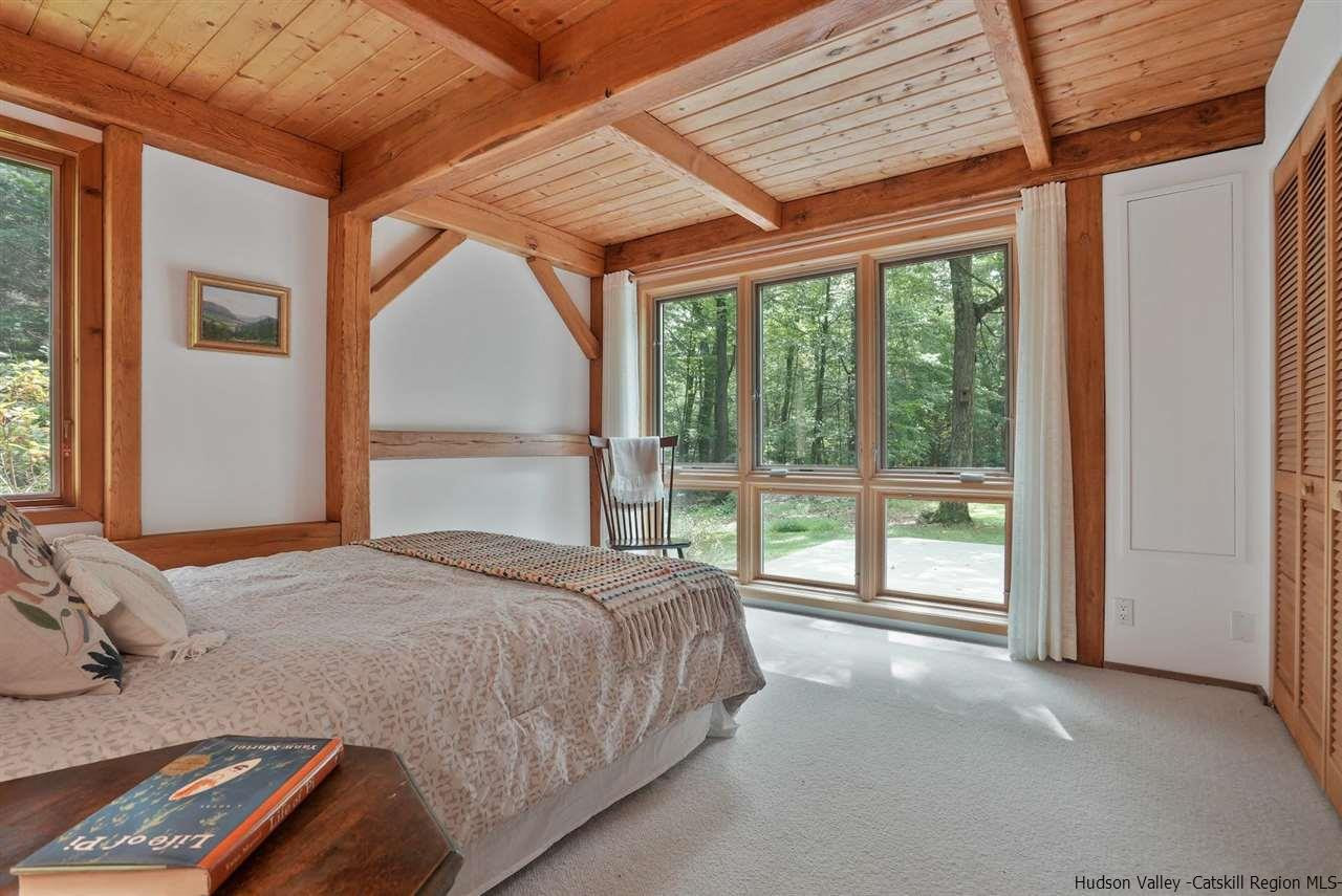 48 Rock Ridge Road New Paltz, NY 12561 - Photo 28 of 35 a bed sitting in a bedroom next to a window