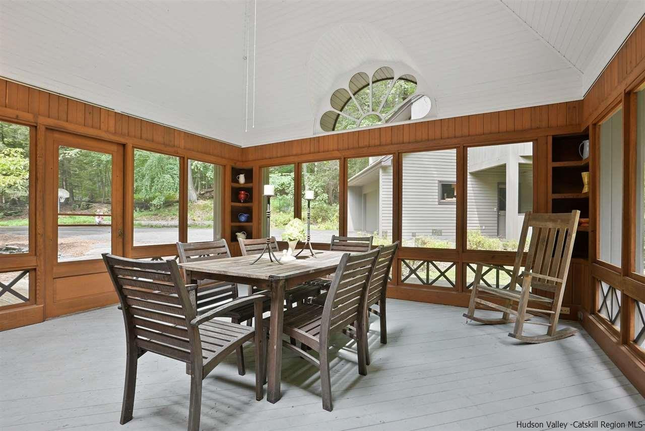 48 Rock Ridge Road New Paltz, NY 12561 - Photo 31 of 35 a view of a dining room with furniture large windows and wooden floor