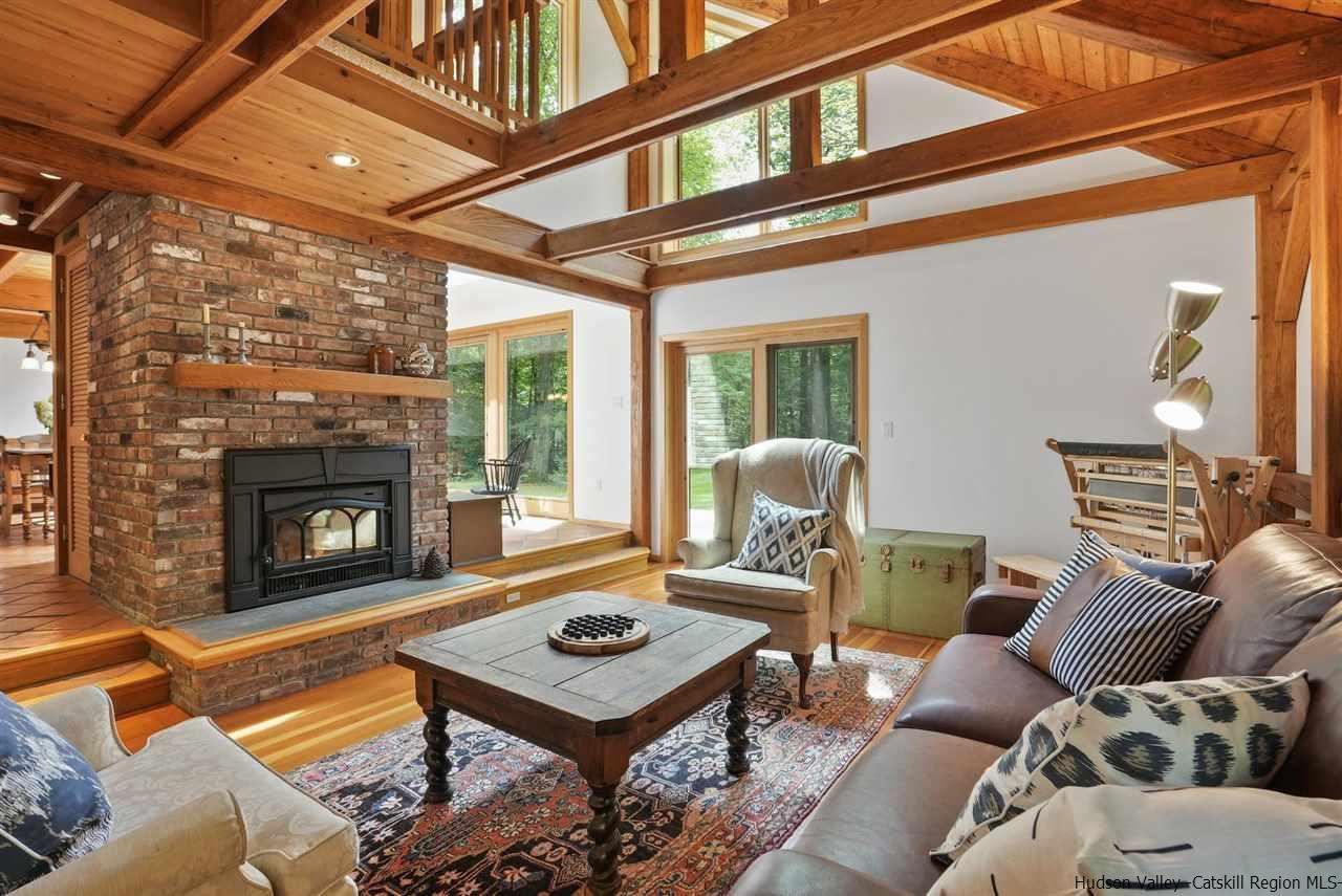 48 Rock Ridge Road New Paltz, NY 12561 - Photo 6 of 35 a living room with furniture a table and a fireplace