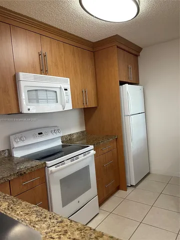 a kitchen with a stove and a microwave