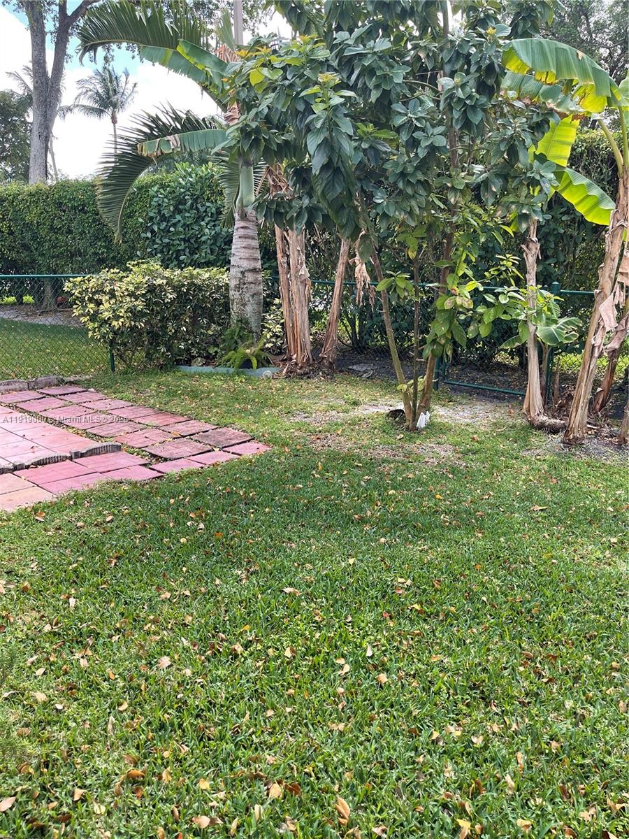 11740 Southwest 19th Street, Unit 11740 Miramar, FL 33025 - Photo 24 of 29 a backyard of a house with table and chairs