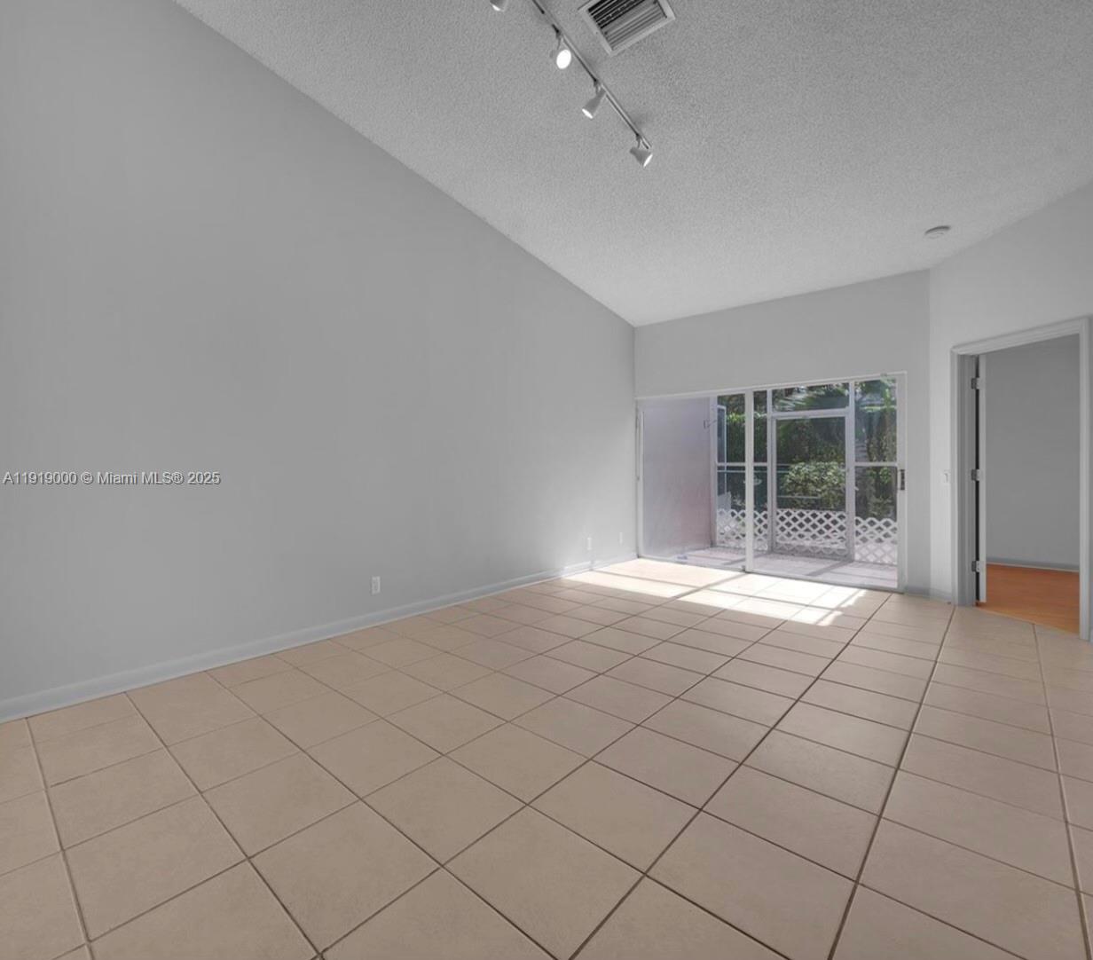 11740 Southwest 19th Street, Unit 11740 Miramar, FL 33025 - Photo 6 of 29 a view of an empty room with a window