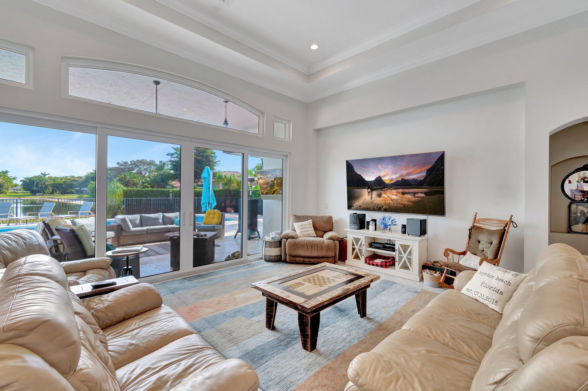 8200 Muirhead Circle Boynton Beach, FL 33472 - Photo 11 of 110 a living room with furniture large window and a flat screen tv