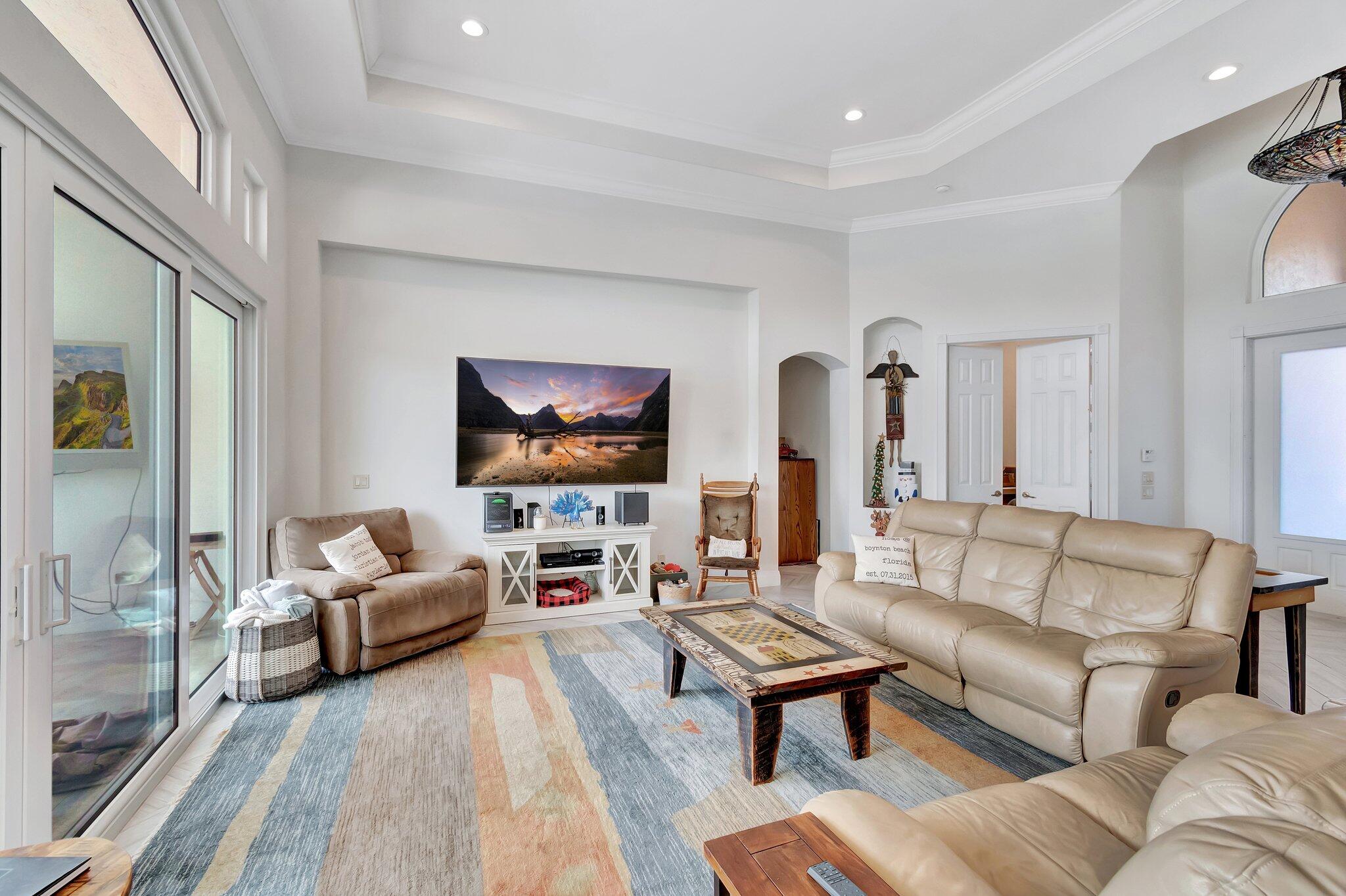 8200 Muirhead Circle Boynton Beach, FL 33472 - Photo 12 of 110 a living room with furniture and a flat screen tv