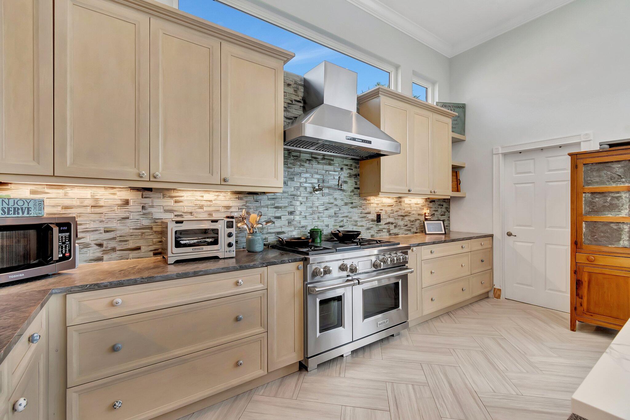 8200 Muirhead Circle Boynton Beach, FL 33472 - Photo 18 of 110 a kitchen with stainless steel appliances granite countertop a stove a sink and a white cabinets
