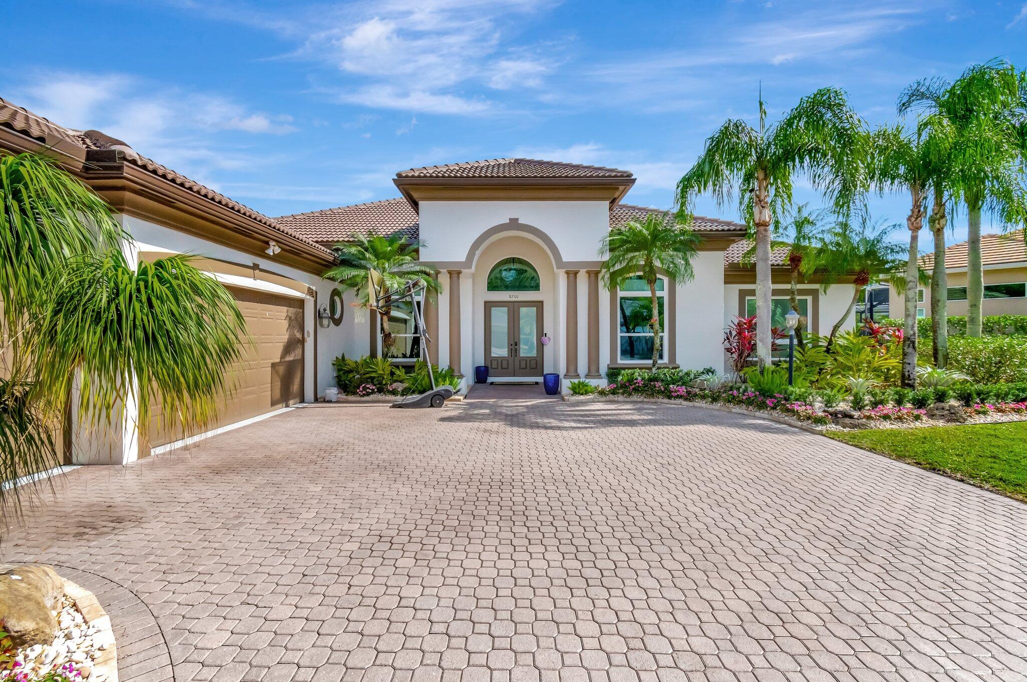 8200 Muirhead Circle Boynton Beach, FL 33472 - Photo 2 of 110 a front view of a house with garden