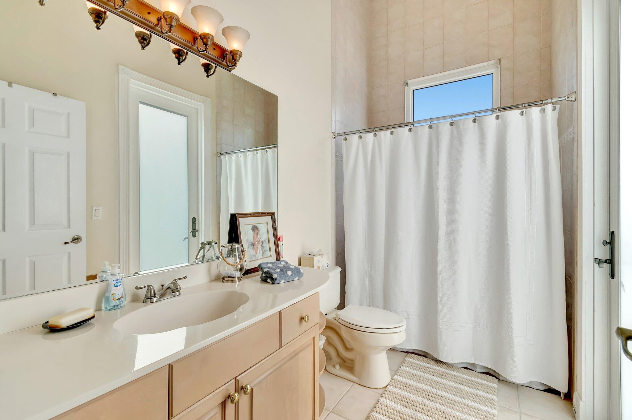 8200 Muirhead Circle Boynton Beach, FL 33472 - Photo 22 of 110 a bathroom with a double vanity sink and a mirror
