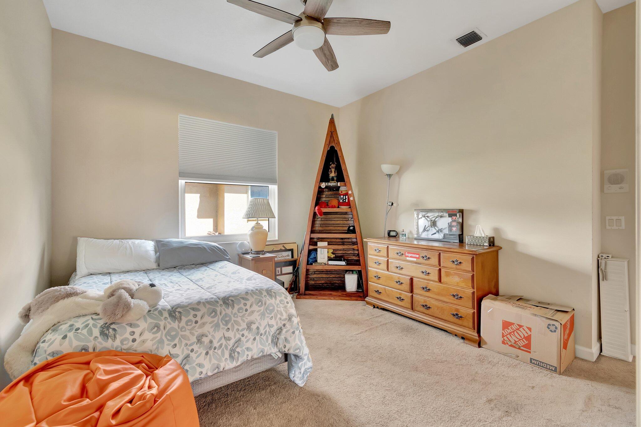 8200 Muirhead Circle Boynton Beach, FL 33472 - Photo 38 of 110 a bedroom with a bed and wooden floor