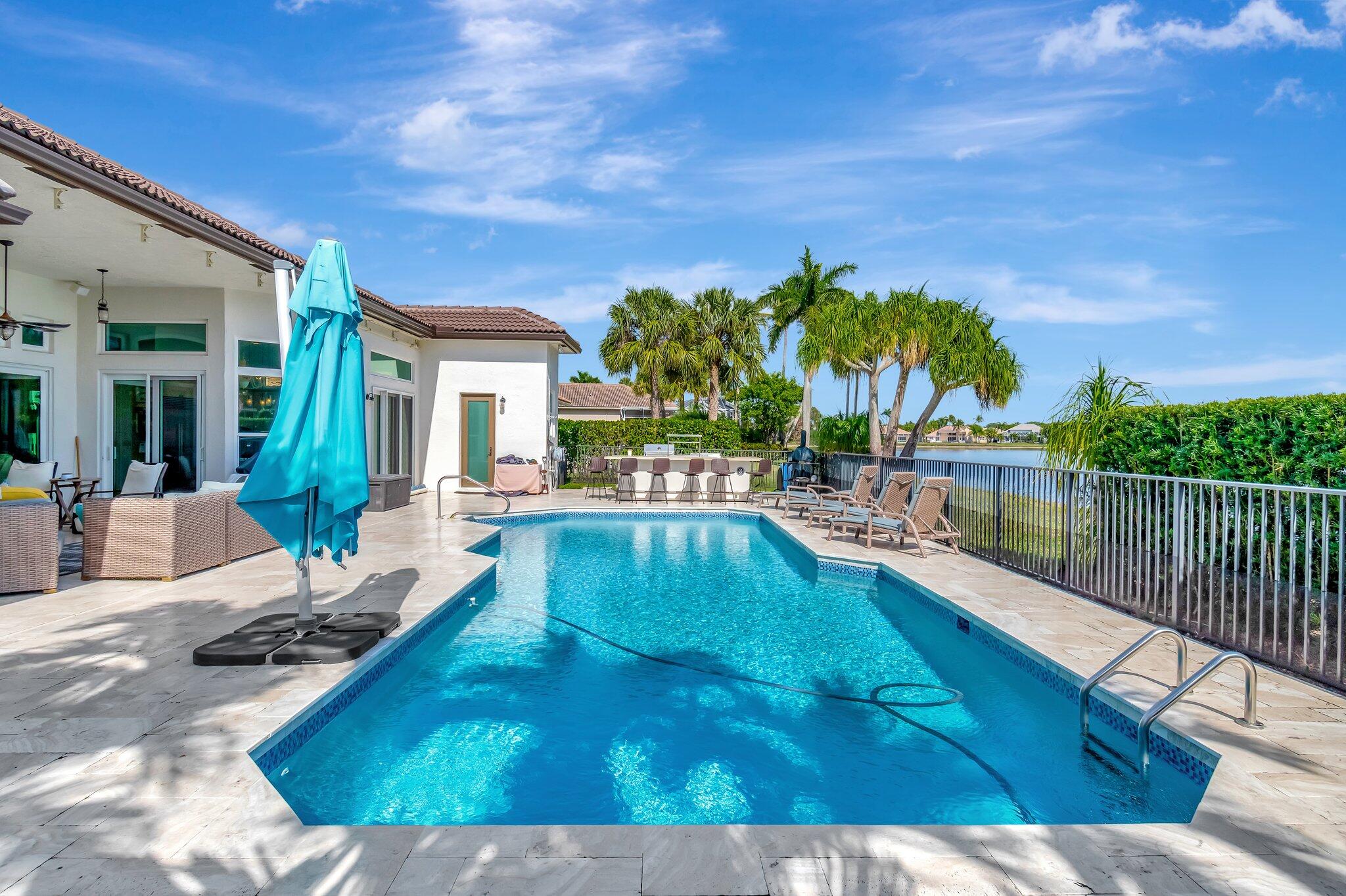 8200 Muirhead Circle Boynton Beach, FL 33472 - Photo 46 of 110 a view of a swimming pool with a lounge chairs