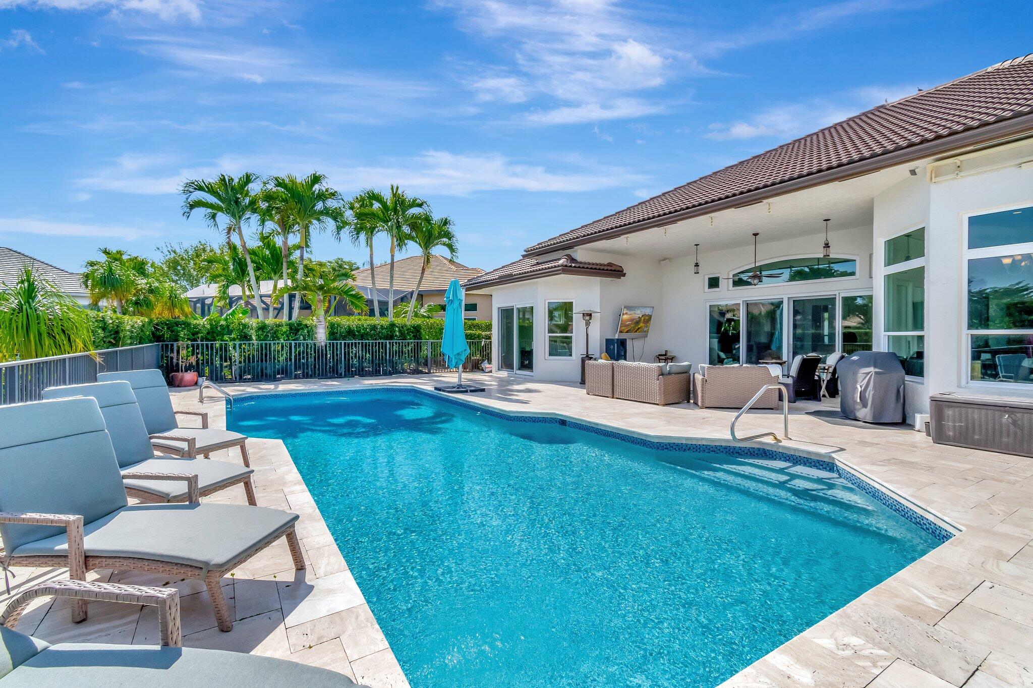 8200 Muirhead Circle Boynton Beach, FL 33472 - Photo 51 of 110 a view of a patio with couches table and chairs with wooden fence and plants