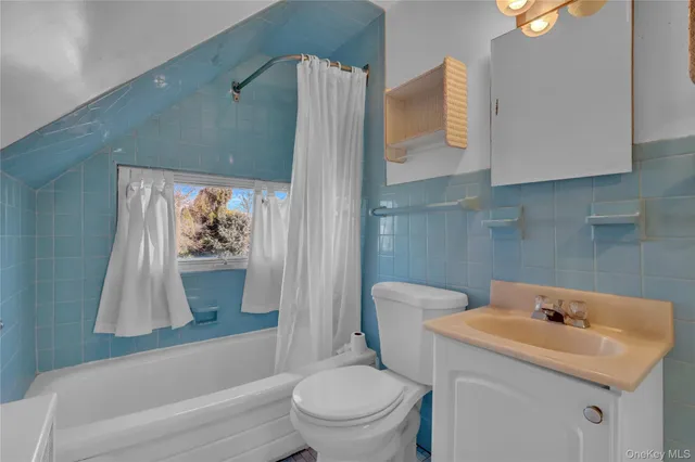 a bathroom with a sink toilet and tub