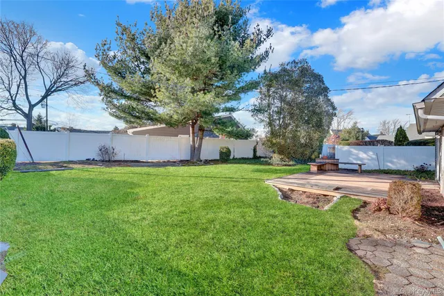 a view of yard with swimming pool and green space