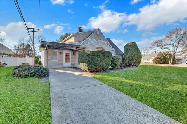 a front view of house with yard and green space