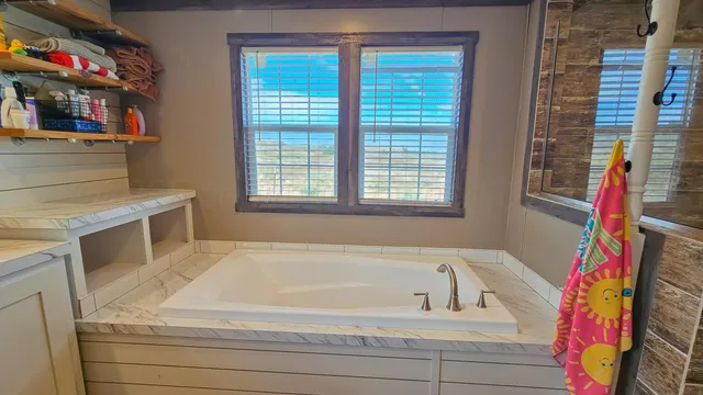 a bathroom with a bathtub and a shower