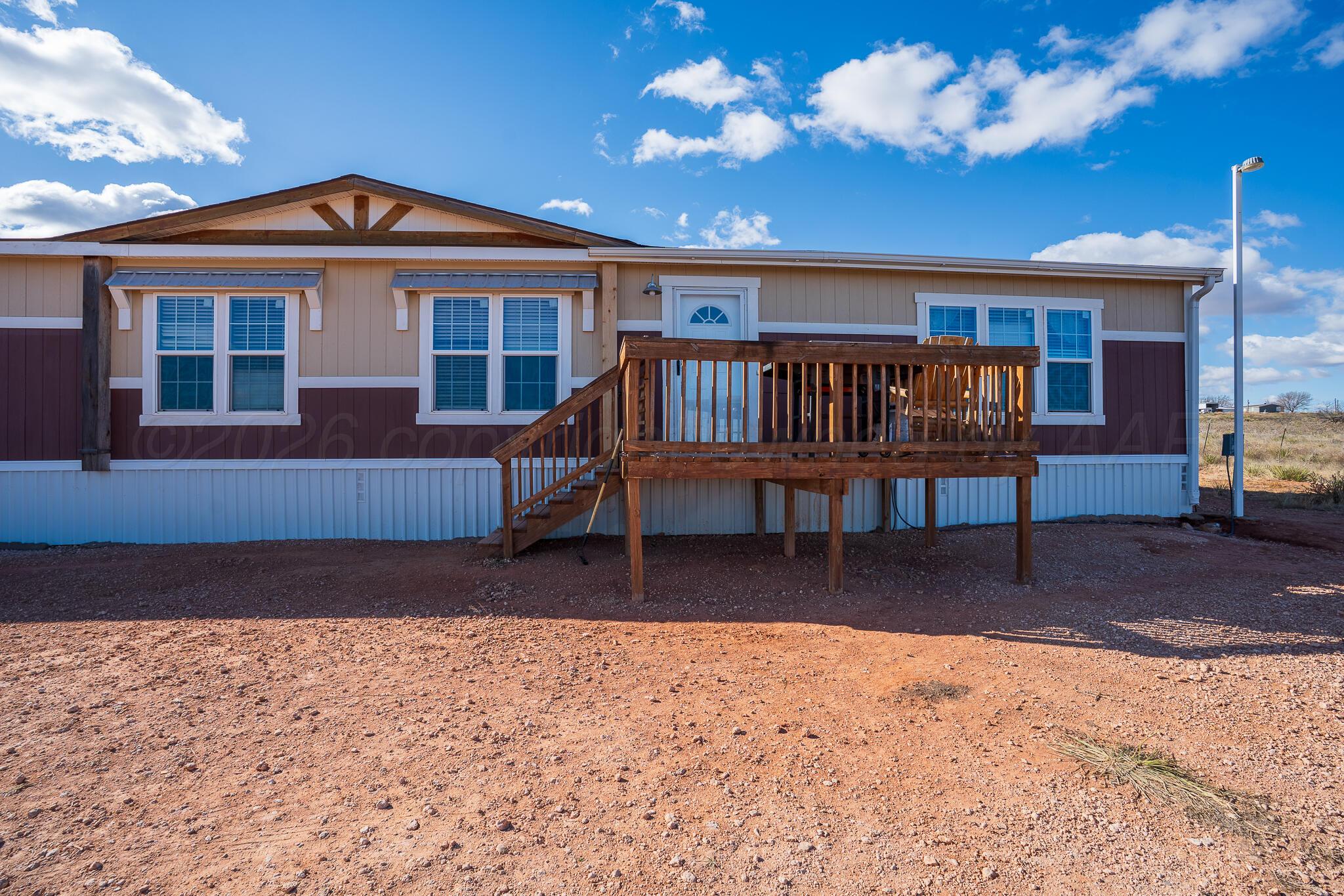24490 RM 1061 Amarillo, TX 79124 - Photo 2 of 32 a view of a house with a patio and a yard