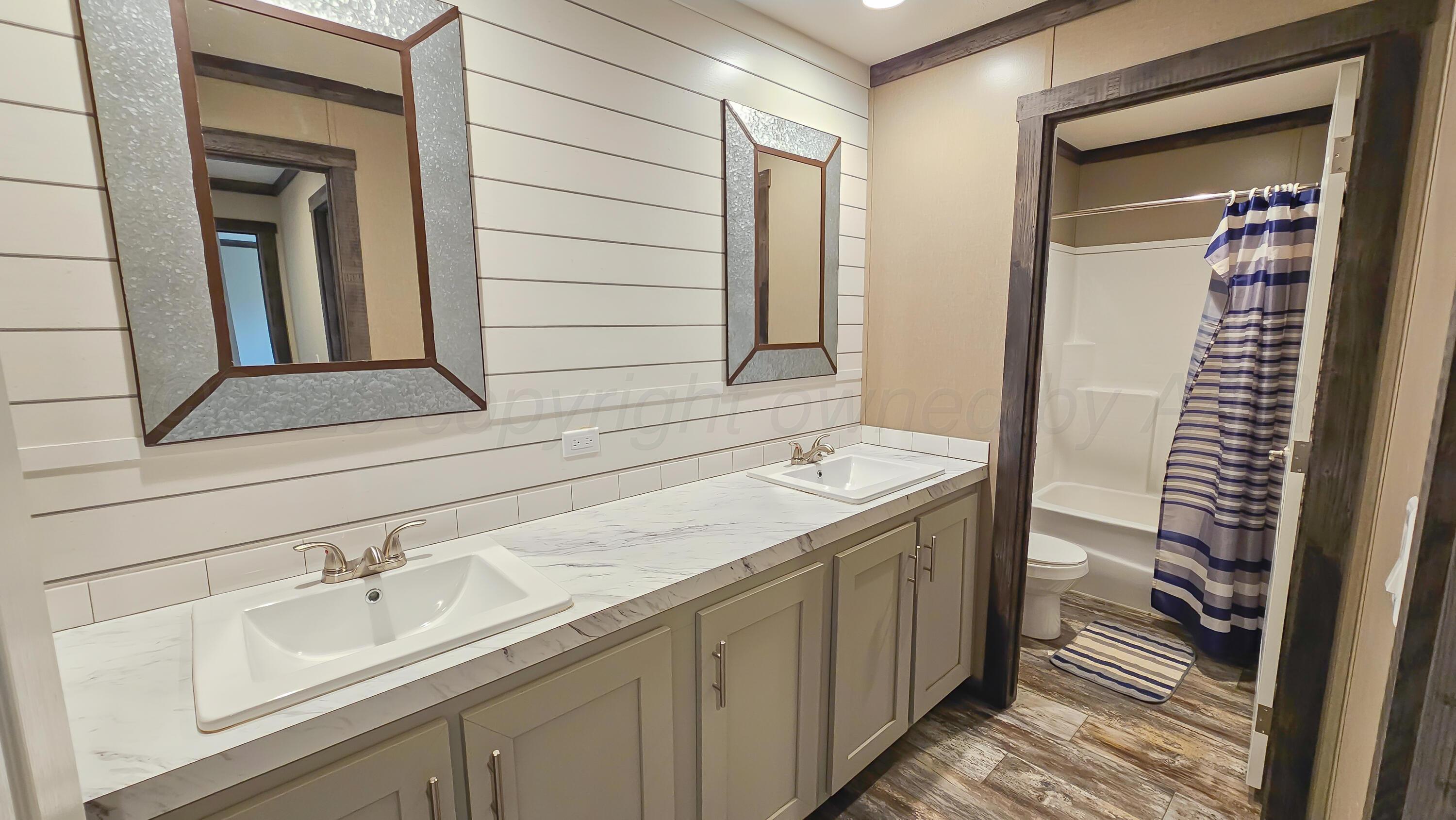 24490 RM 1061 Amarillo, TX 79124 - Photo 24 of 32 a bathroom with a sink and a mirror