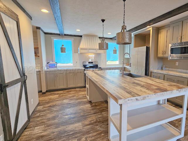 24490 RM 1061 Amarillo, TX 79124 - Photo 6 of 32 a kitchen with stainless steel appliances granite countertop a kitchen island hardwood floor and a sink