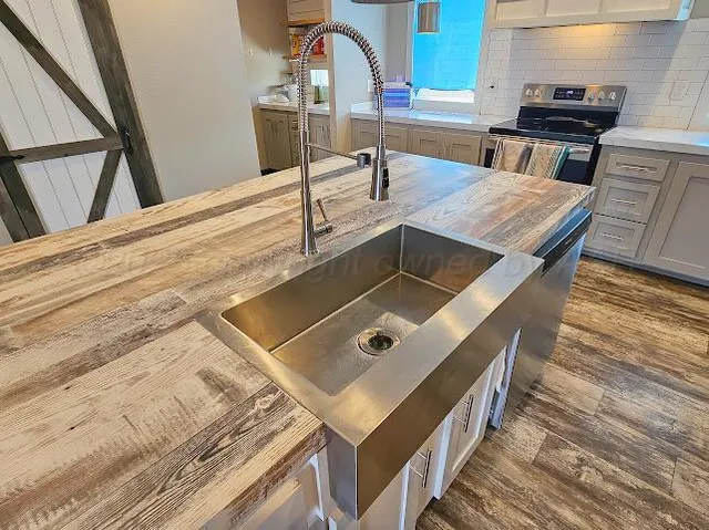 a kitchen with white cabinets and a sink