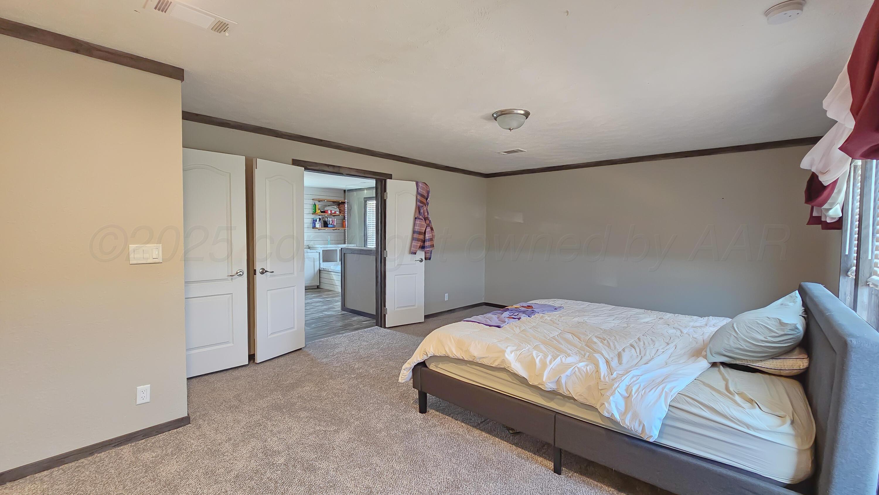 24490 RM 1061 Amarillo, TX 79124 - Photo 10 of 20 a bedroom with a bed and walk in closet