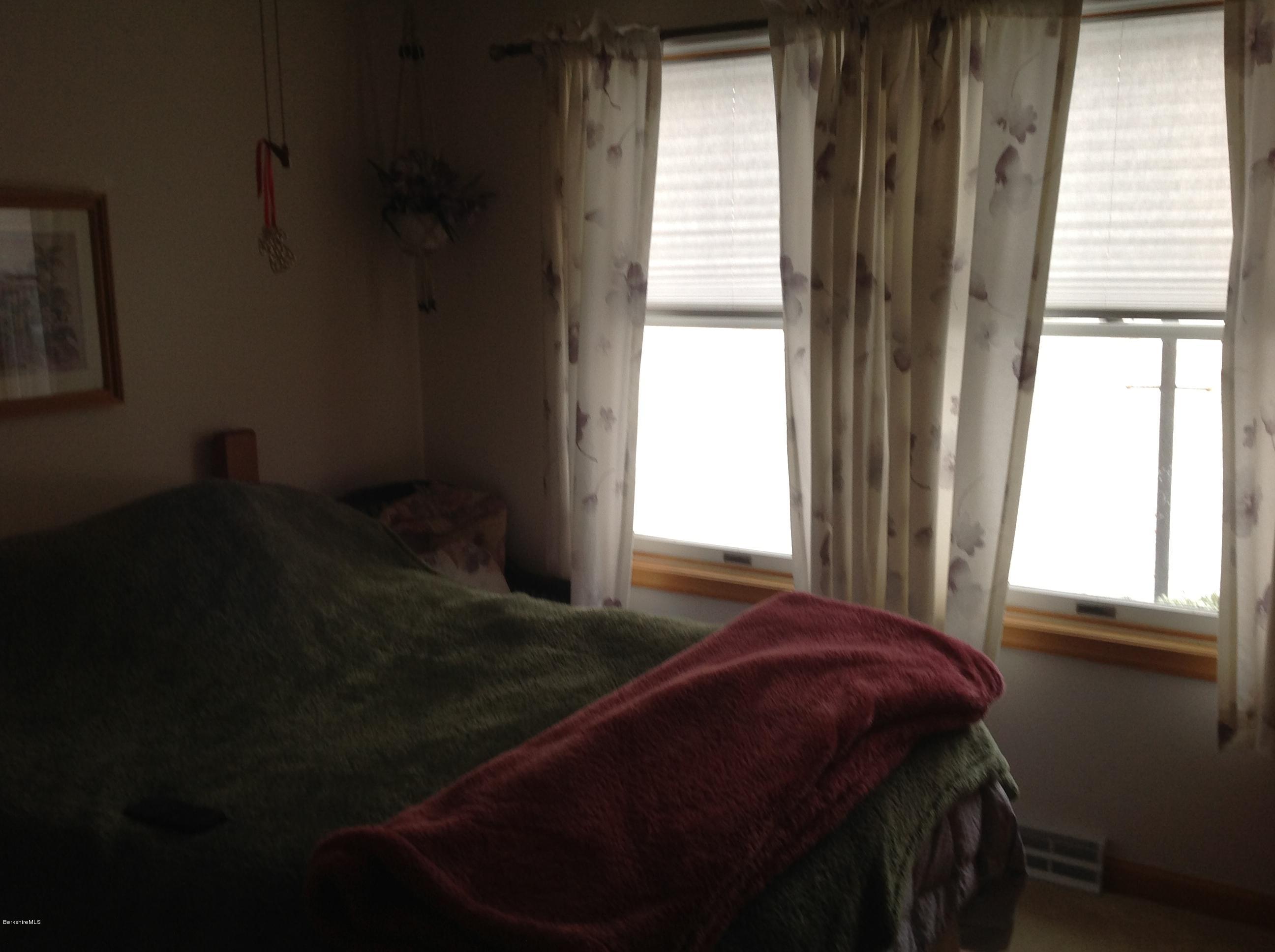 243 Bunce Road South Sheffield, MA 01222 - Photo 16 of 18 a bed sitting in a bedroom next to a window