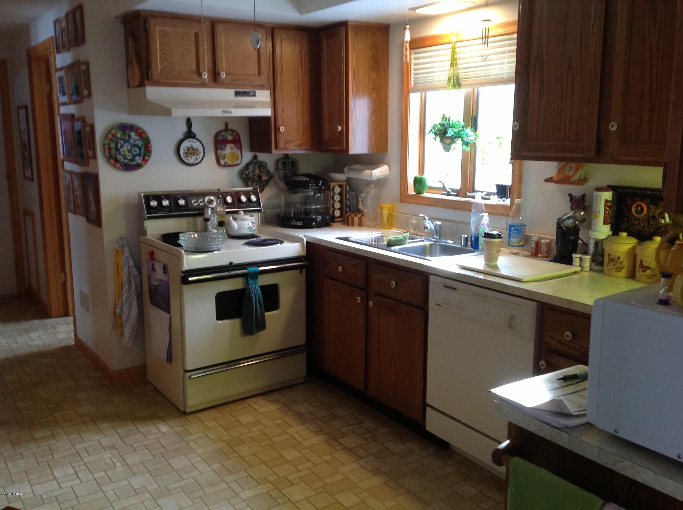 243 Bunce Road South Sheffield, MA 01222 - Photo 7 of 18 a kitchen with a stove window and cabinets