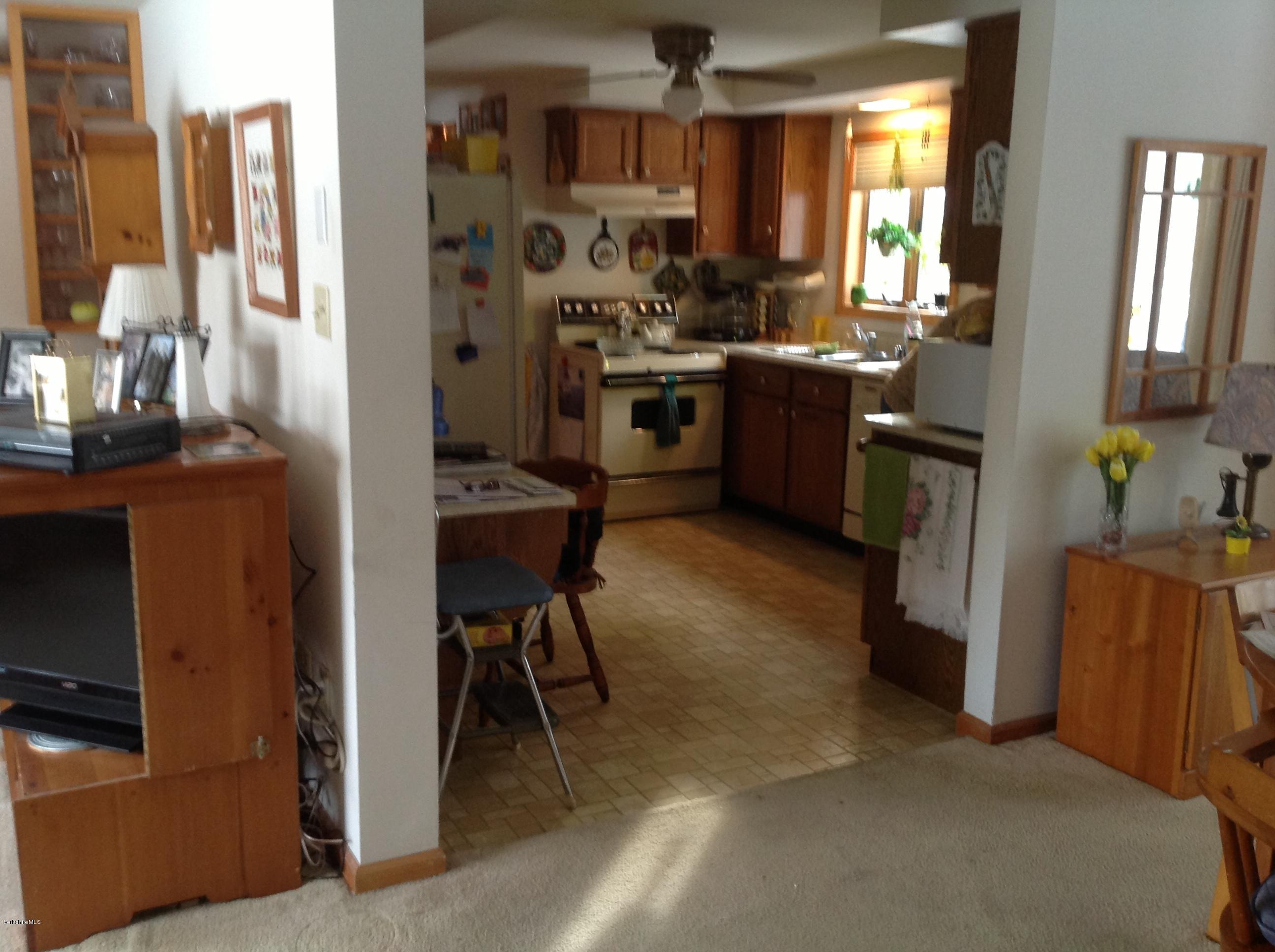 243 Bunce Road South Sheffield, MA 01222 - Photo 8 of 18 a kitchen with stainless steel appliances kitchen island granite countertop a refrigerator and a stove top oven