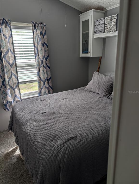 475 Pine Loop Frostproof, FL 33843 - Photo 13 of 40 a bedroom with a bed and a window
