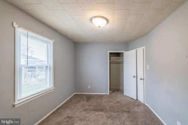 a open kitchen with stainless steel appliances granite countertop a stove top oven a sink and a island with wooden floor