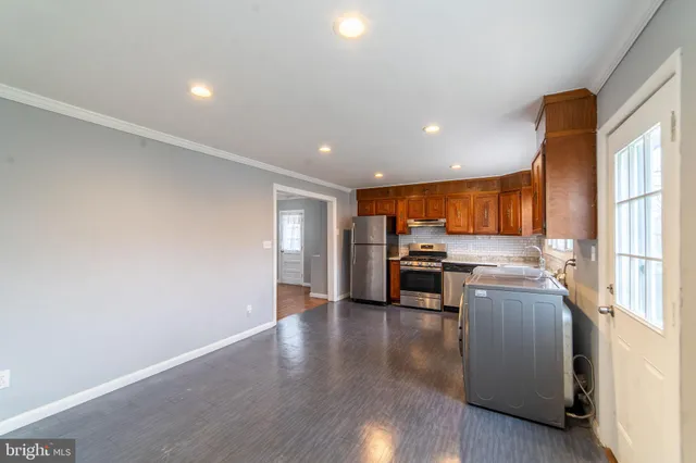a kitchen with a refrigerator and a stove top oven