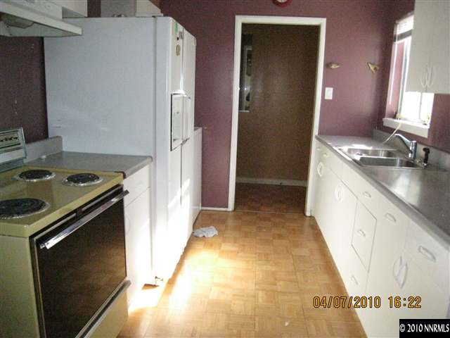 1225 Trainer Way Reno, NV 89512 - Photo 3 of 6 a kitchen with a stove and a refrigerator
