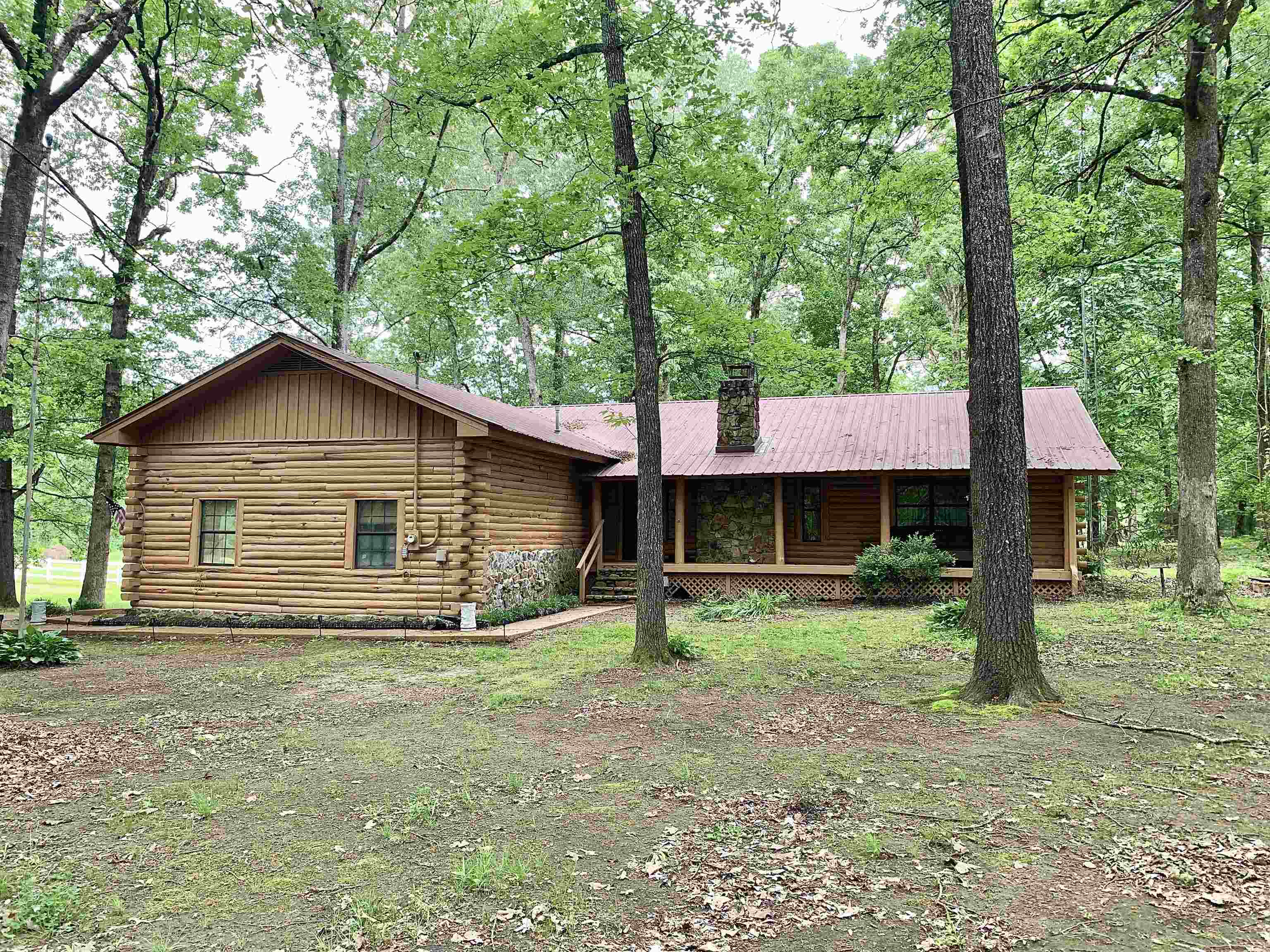4560 Bishop Road Middleton, TN 38052 - Photo 1 of 40 Log home featuring log siding, a chimney, and covered porch