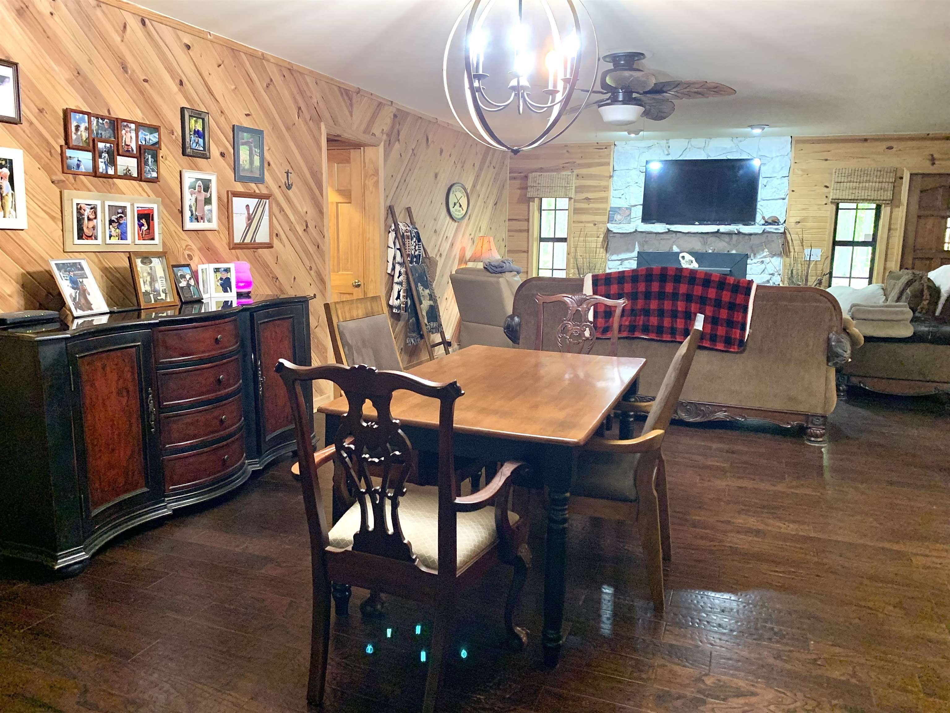 4560 Bishop Road Middleton, TN 38052 - Photo 14 of 40 Dining area featuring wooden walls, wood-type flooring, and a healthy amount of sunlight