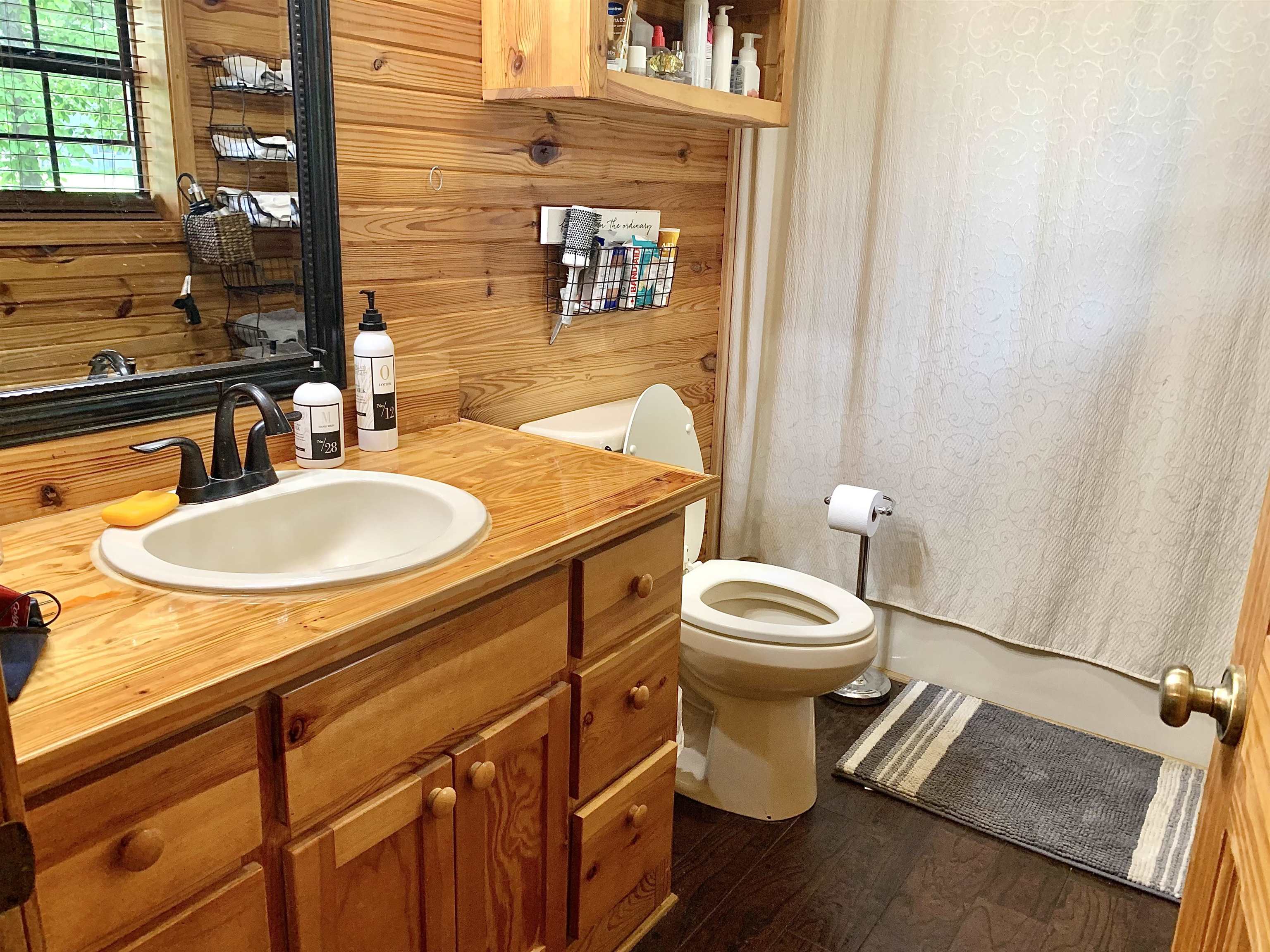4560 Bishop Road Middleton, TN 38052 - Photo 25 of 40 Bathroom featuring vanity, toilet, wooden walls, and wood finished floors