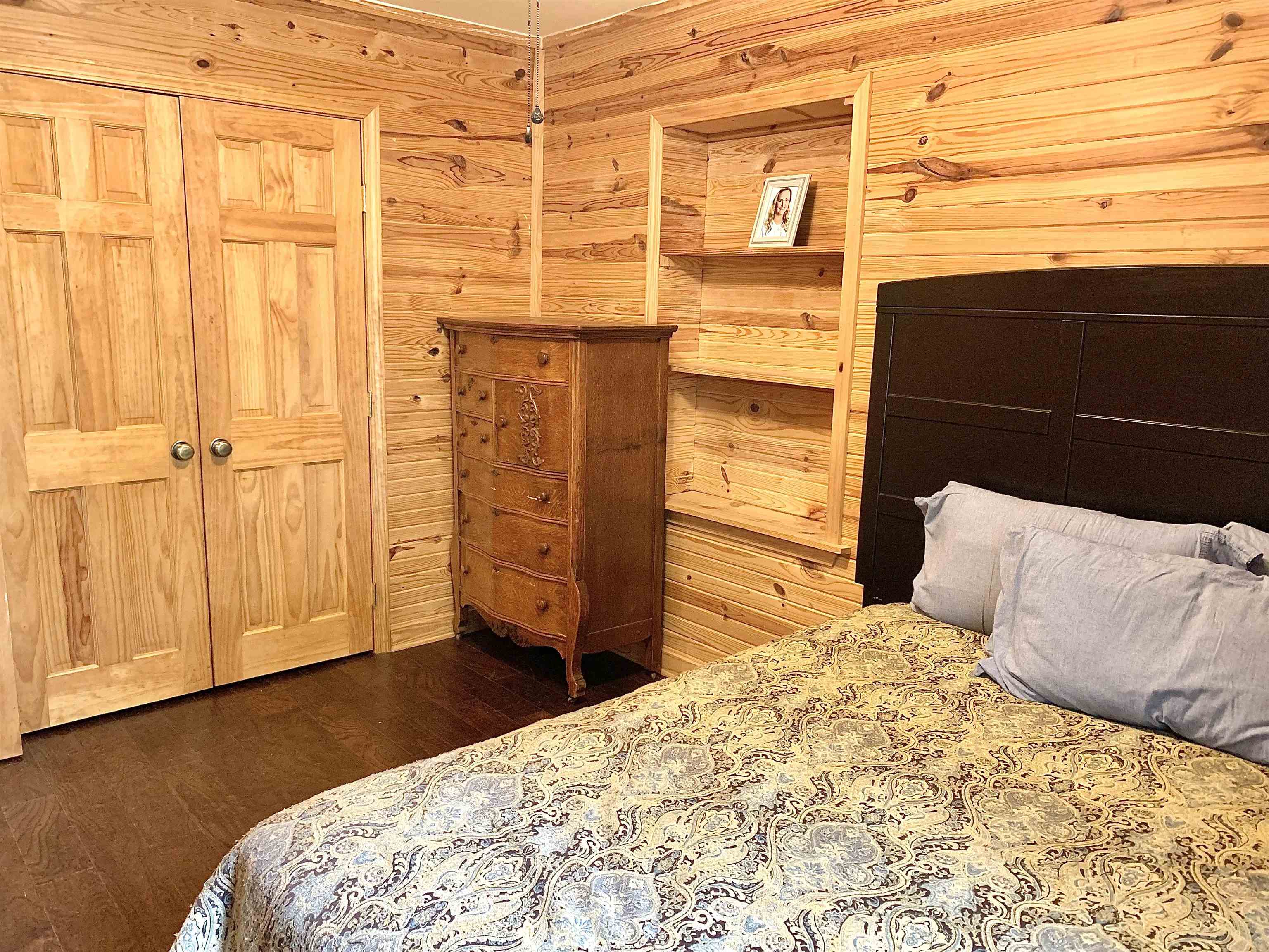 4560 Bishop Road Middleton, TN 38052 - Photo 27 of 40 Bedroom with dark wood finished floors and wood walls