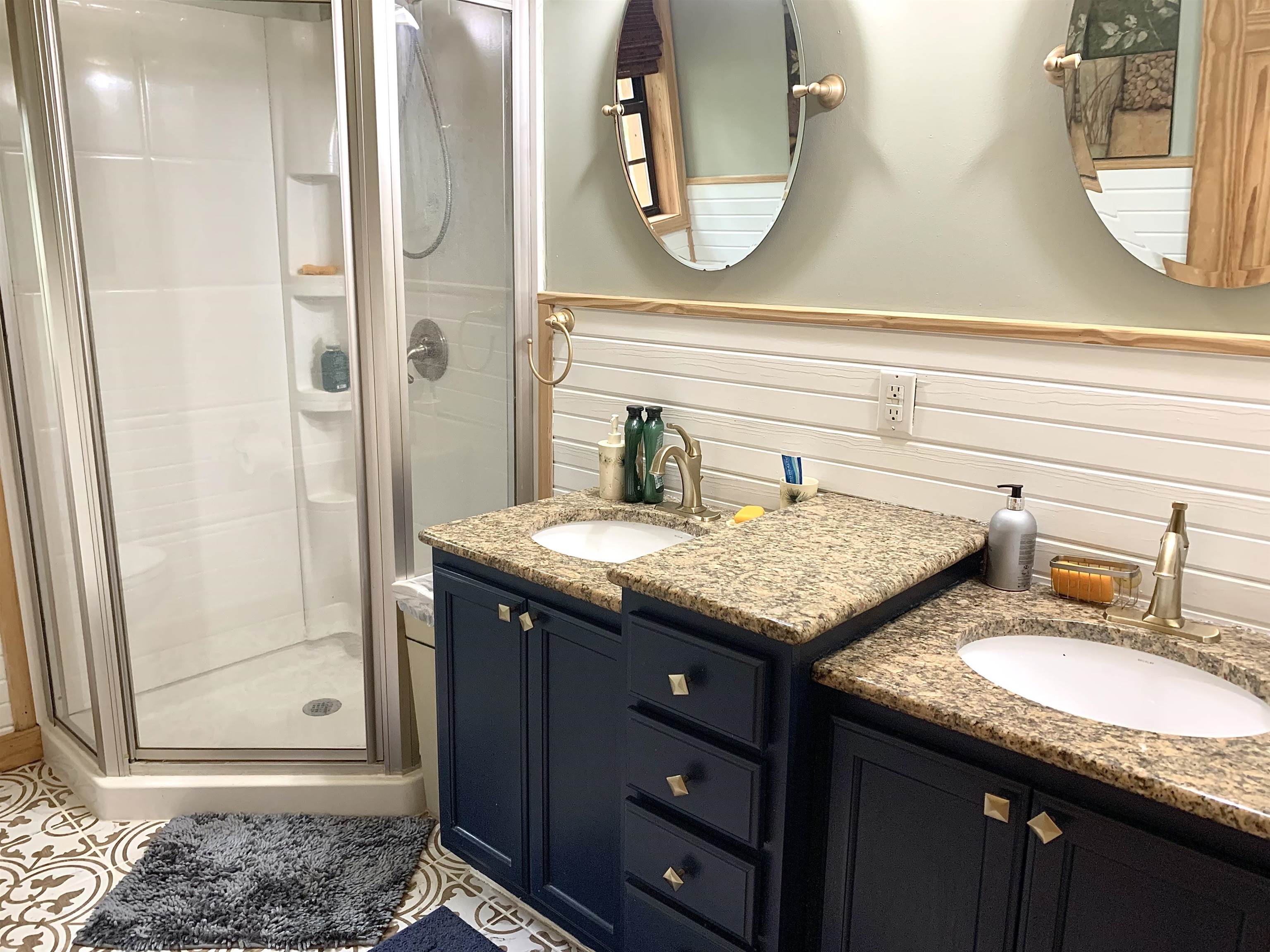 4560 Bishop Road Middleton, TN 38052 - Photo 29 of 40 Full bathroom featuring wainscoting, vanity, and a shower stall