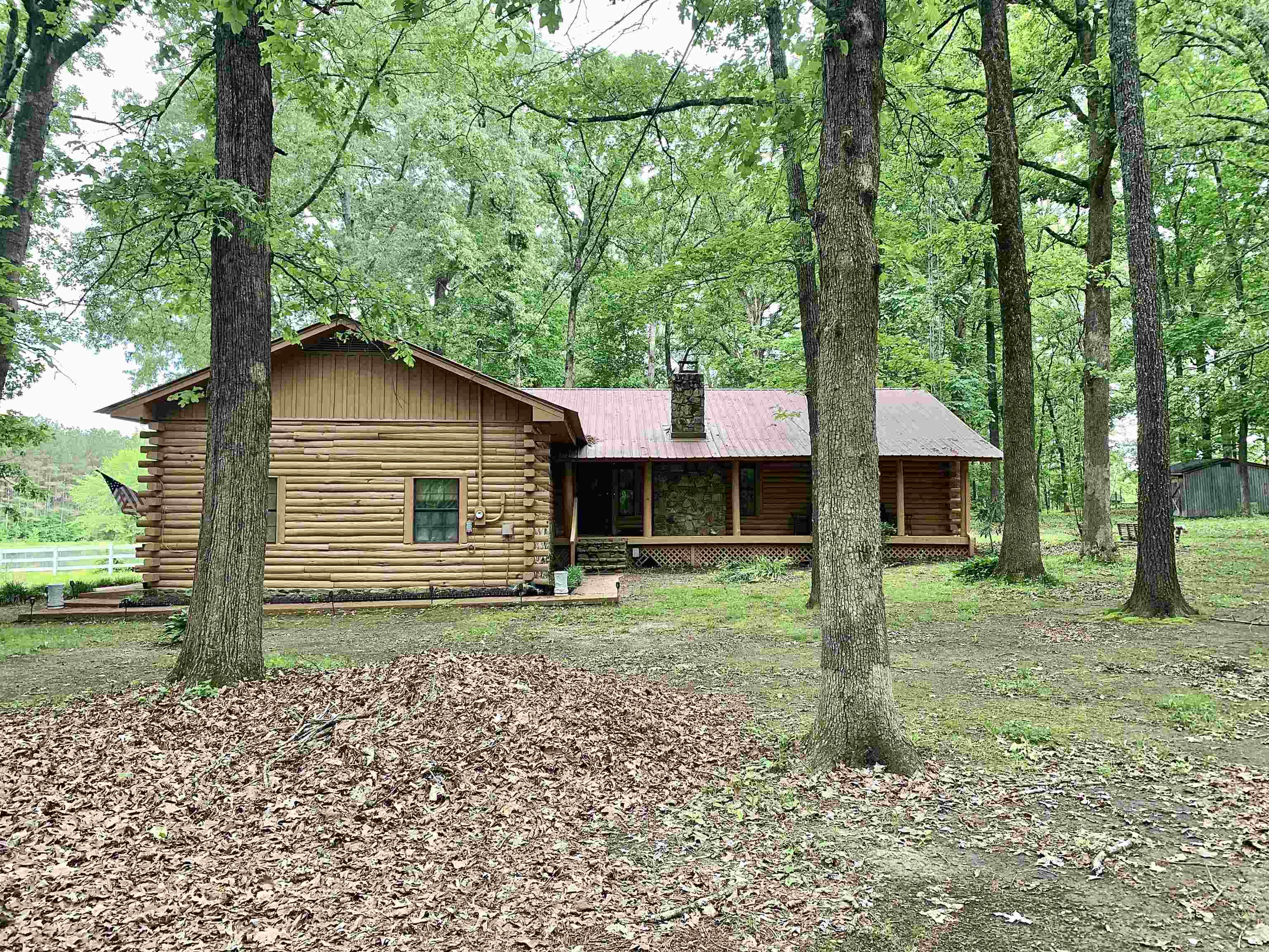 4560 Bishop Road Middleton, TN 38052 - Photo 3 of 40 Cabin with log siding, a chimney, and a porch