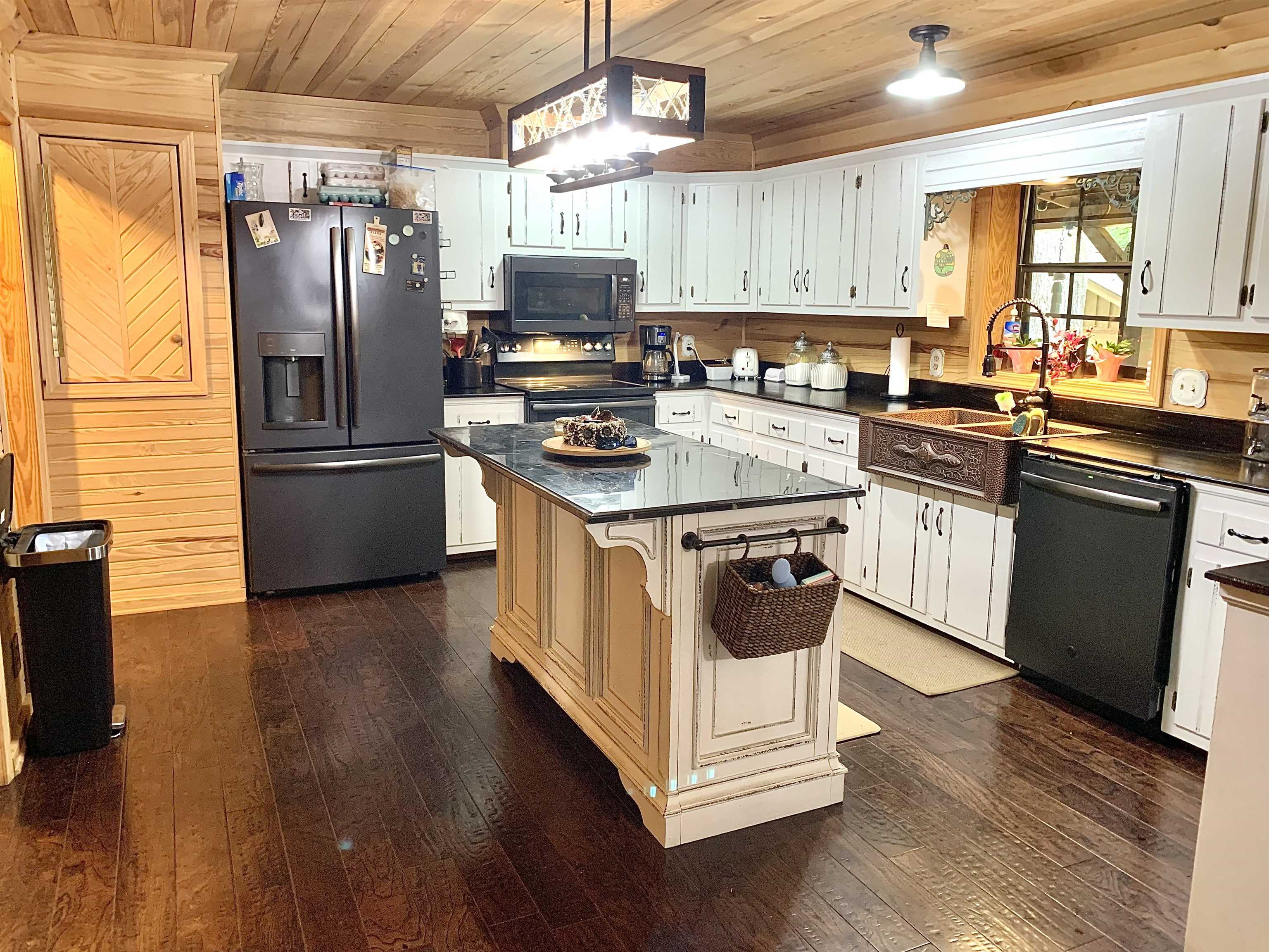4560 Bishop Road Middleton, TN 38052 - Photo 7 of 40 Kitchen with a sink, dark countertops, dark wood-style flooring, black appliances, and wooden ceiling