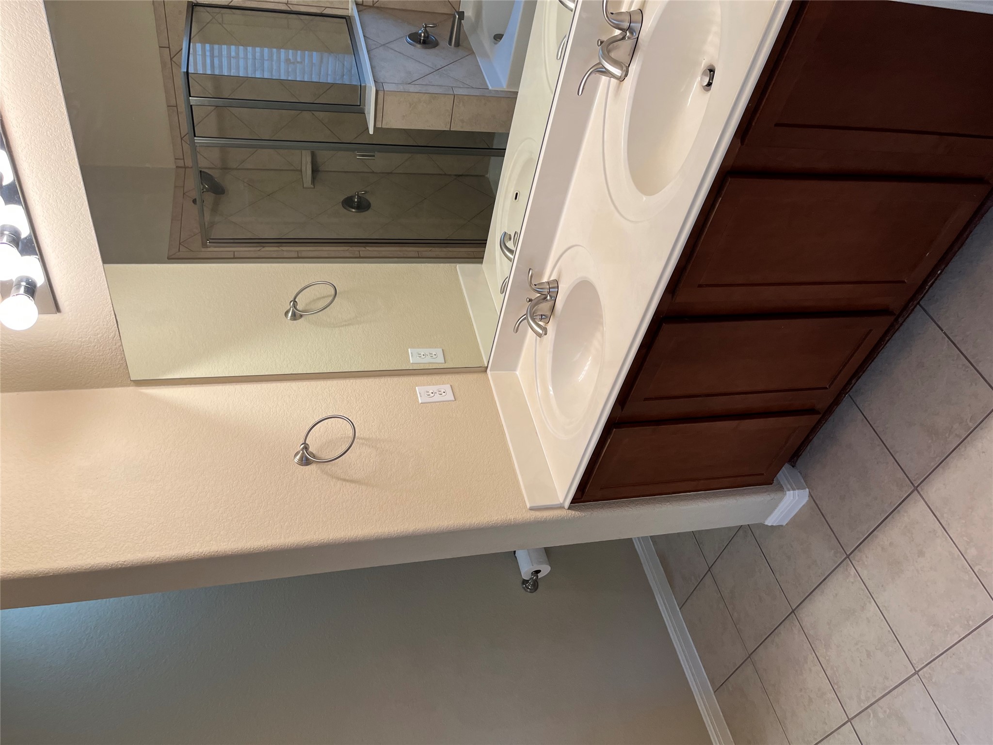 1501 Rimstone Drive Cedar Park, TX 78613 - Photo 11 of 20 Master bathroom with double vanity, a bath, a stall shower, light tile patterned floors, and a textured wall