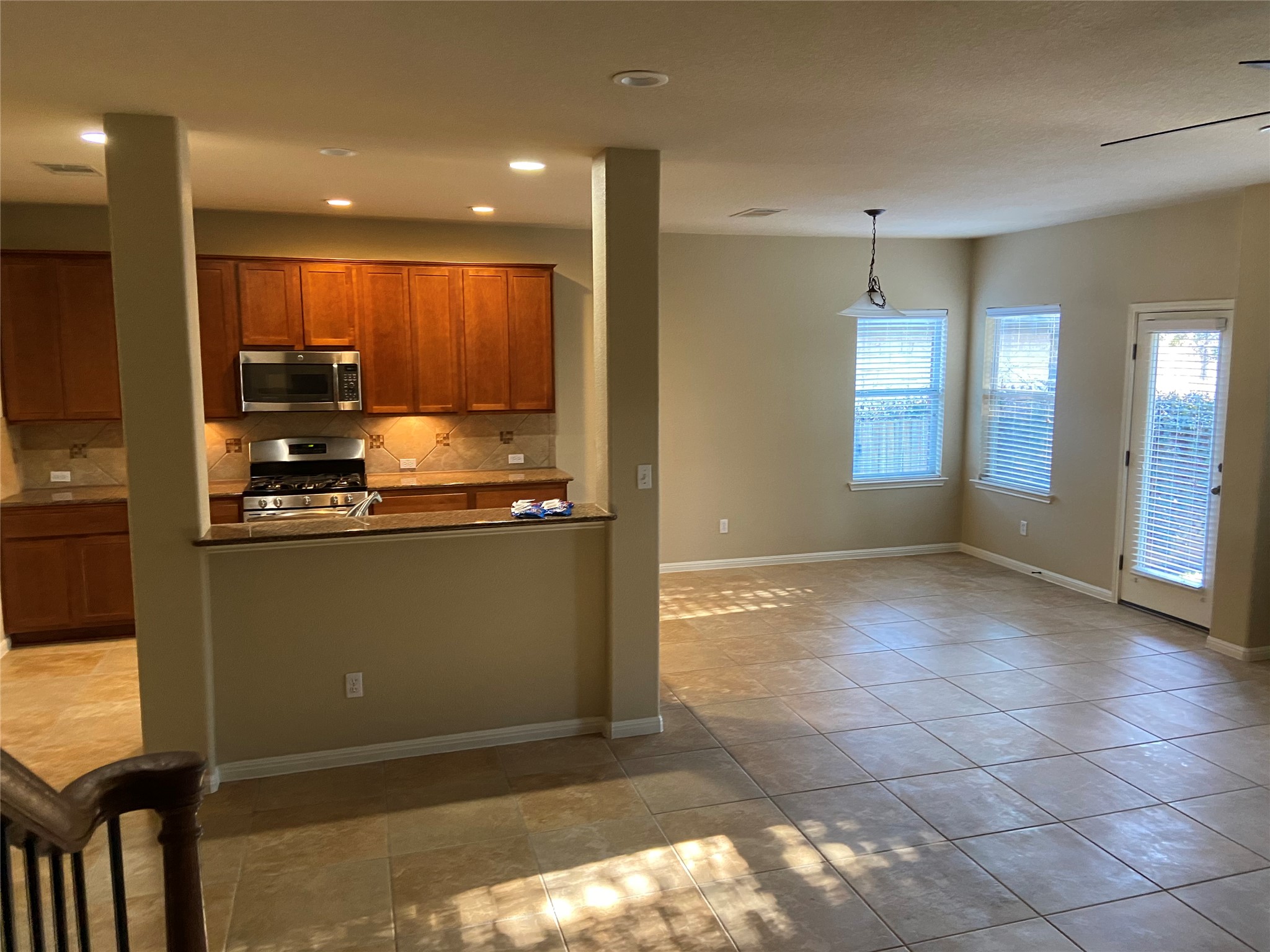 1501 Rimstone Drive Cedar Park, TX 78613 - Photo 5 of 20 Kitchen featuring wood finish cabinetry, stainless steel appliances, light tile patterned flooring, dark countertops, and backsplash