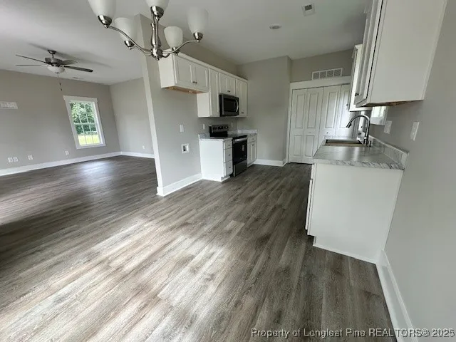 a kitchen with a sink stainless steel appliances and cabinets