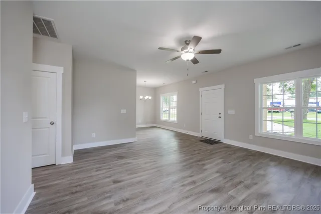 a view of a kitchen with a sink cabinets and wooden floor